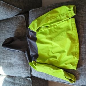 The North Face lime green and gray lightweight waterproof windbreaker jacket.
